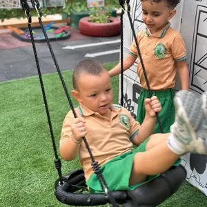 A child on a swing in the outdoor garden