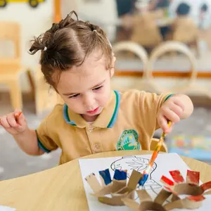 A child painting at the art table