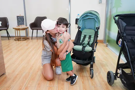 A parent saying goodbye to a child at the nursery reception